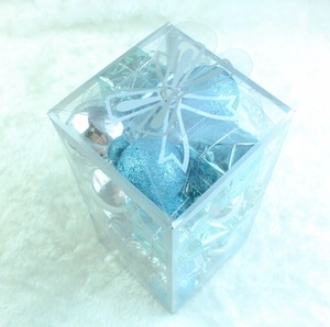 Blue and silver Christmas ball ornaments in different finishes inside a clear PVC box