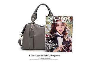 Grey Boston bag shown next to a magazine to demonstrate size and storage capacity