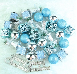 Blue Christmas tree ornaments set with glitter balls, bells, and Merry Christmas sign