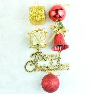 Close-up of assorted red and gold Christmas ornaments on white faux fur background