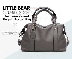 Detailed view of dark grey litchi texture leather Boston bag with gold hardware