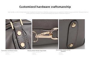 Detail of grey lychee leather bag featuring light gold hardware hooks and metal feet