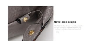 Detail of grey lychee leather Boston bag showing side folding design with gold snap button