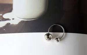 Minimalist S925 sterling silver open ring with double polished spheres on fashion magazine