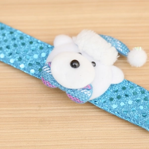 Close-up of blue sequin Christmas slap bracelet featuring a plush polar bear charm