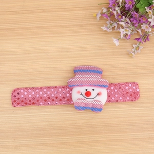 Detail of pink Christmas slap bracelet with shiny sequins and a plush snowman decoration
