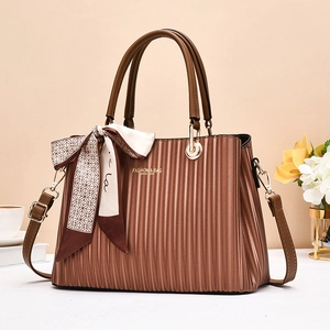 Brown accordion pleated leather handbag with decorative scarf and golden hardware accents