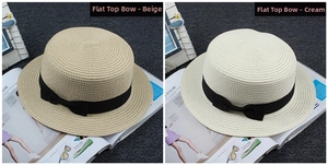 Flat top straw sun hat featuring elegant black ribbon bow detail in beige and cream white