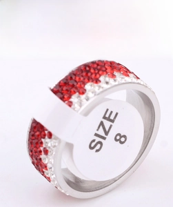 Detailed shot of 8mm stainless steel ring with red and white rhinestones and size 8 tag
