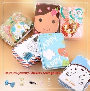 Detail view of assorted rectangular tin boxes with colorful cartoon patterns for small items