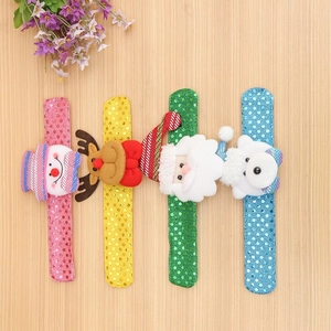 Assorted Christmas sequin slap bracelets with snowman, reindeer, and Santa on wood background