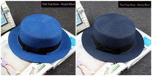 Detail view of royal blue and navy boater hats with chic black ribbon bows