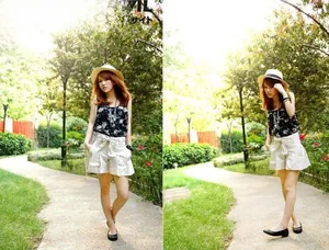 Detail of a floral sleeveless top paired with beige high-waisted shorts and a straw hat