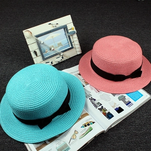 Flat top woven straw boatier hats in blue and pink with black ribbon bow for summer beach