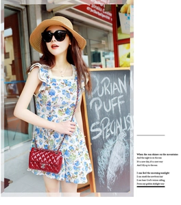 Chic model wearing a foldable wide brim straw sun hat with an elegant summer dress