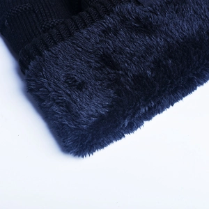 Detailed close-up of thick fleece lining and knit texture for winter thermal hat