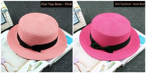 Flat top straw boater hats with black ribbon bows in pink and fuchsia colors