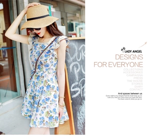 Detail of blue floral sleeveless summer dress with ruffled hem in a French rural style
