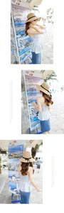Detail view of foldable straw sun hat with black ribbon and floral ruffled camisole top