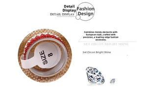 Detailed close-up of 8mm stainless steel ring with red and white zircon insets, size 8