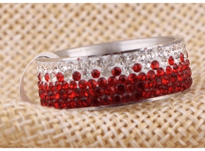 Close-up of 8mm stainless steel ring featuring gradient red and white micro-pave crystals