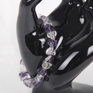 Transparent beaded bracelet with purple H-cut crystal beads on black hand model