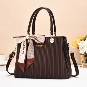 Elegant dark brown pleated handbag with a decorative silk scarf and adjustable strap