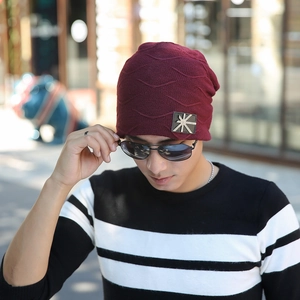 Winter fleece-lined burgundy knit beanie with star metal logo for outdoor warmth