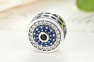 Macro shot of 925 sterling silver evil eye charm bead with blue and white zirconia