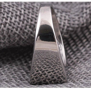 Macro shot of minimalist rectangular stainless steel ring with high-polish mirror finish