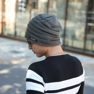 Detail of dark grey knit beanie showing fine horizontal texture and Fashion brand label