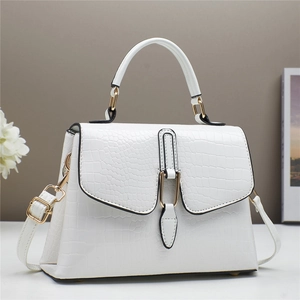White crocodile embossed leather handbag with gold metal hardware and adjustable strap