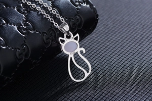 Macro detail of rose gold cat pendant necklace with S925 silver hallmarks and pink crystal