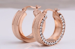 Close-up of 8mm rose gold stainless steel hoop earrings with crystals and frosted finish