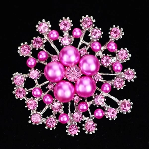 Exquisite silver snowflake brooch with pink pearls and crystals on black background