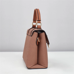 Detail of brown woven shoulder bag showing accordion pleats and gold hardware