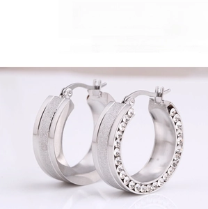 Detail of 8mm silver stainless steel earrings with frosted finish and inlaid crystals
