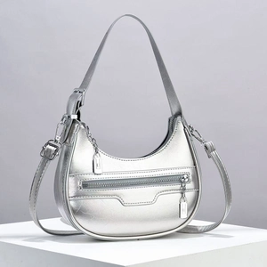 Silver metallic crescent moon hobo bag with adjustable strap and chain detail