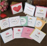 Mini square blessing cards with colorful patterns and birthday wishes on dark background
