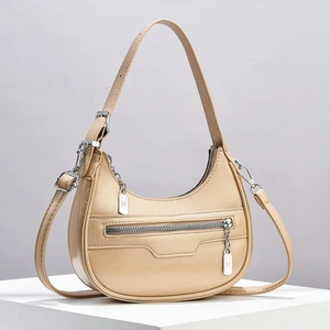 Fashionable apricot crescent moon shoulder bag with silver hardware and adjustable strap