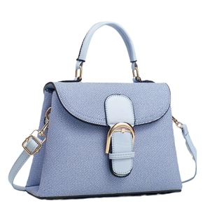 Light blue denim trapezoid handbag with gold horse-bit buckle and crossbody strap