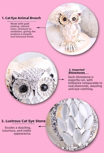 Close-up of golden owl brooch with white opal stone and sparkling rhinestones