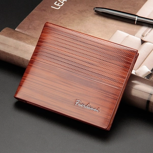 Classic brown men's bifold wallet with wood texture finish next to a vintage pen