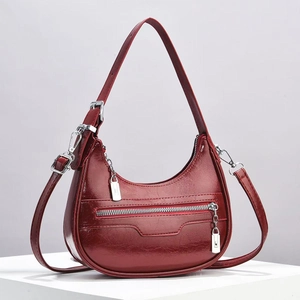 Chic burgundy crescent hobo bag with vintage leather texture and silver hardware