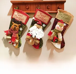 Three festive Christmas stockings featuring Santa, Reindeer, and Snowman on wooden rack