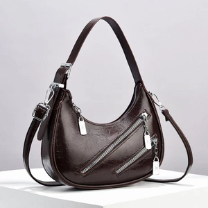 Chic coffee brown crescent crossbody bag in oily wax leather with silver hardware