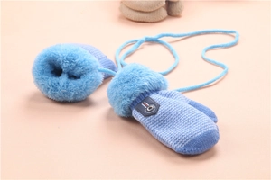 Close-up of blue knitted baby mittens featuring soft faux fur cuffs and anti-lost string
