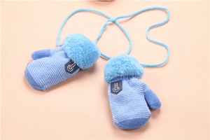 Close-up of blue knitted toddler mittens with plush faux fur cuffs and a neck string
