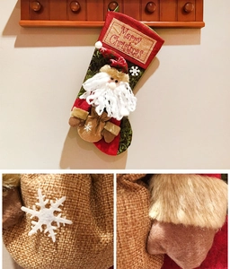 Detailed view of burlap Christmas stocking with Santa Claus applique and plaid fabric