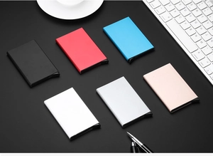 Flat lay of multiple colored aluminum RFID blocking card holders on a business desk